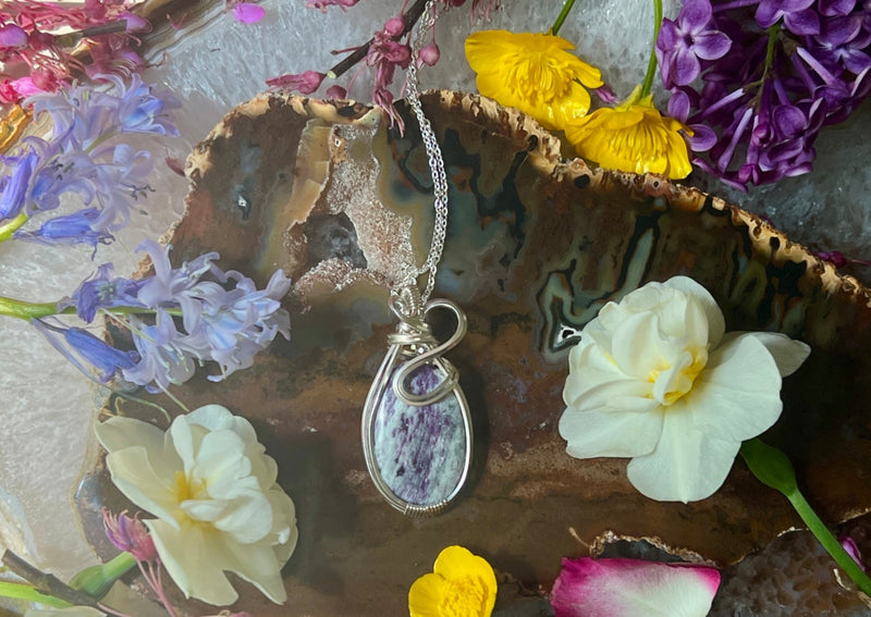 purple crystal with silver chain.