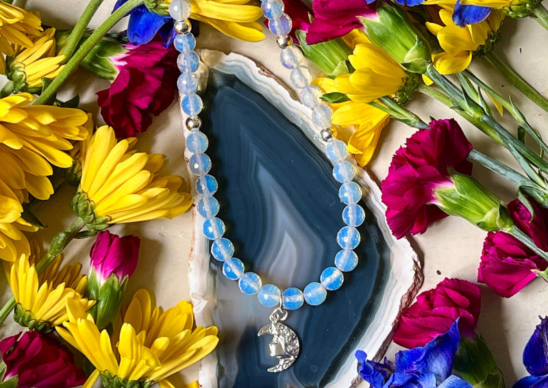 Faceted Opalite beads with sterling silver accent beads, clasp and lady in the moon charm.