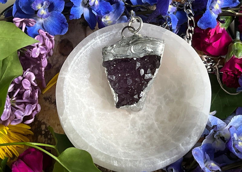 amethyst cluster hanging on chain in selenite bowl
