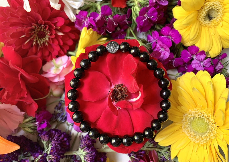 one dark black jet crystal bracelet on a rose