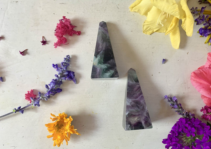 rainbow fluorite pyramids containing green, purple, black colors 