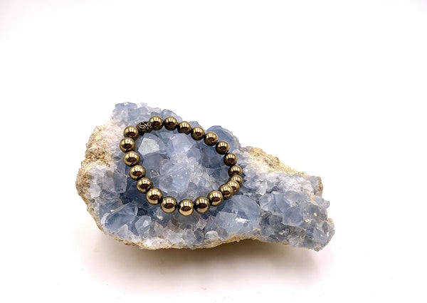 gold pyrite beads on a blue crystal cluster.