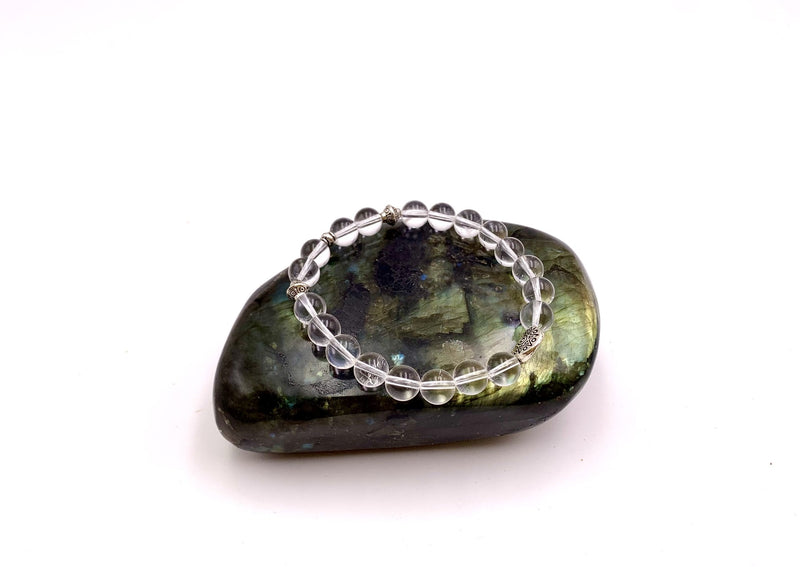 clear quartz beads on green stone.