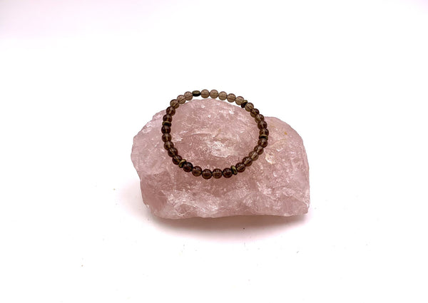 smokey brown small smokey quartz beads on a pink rose quartz cluster