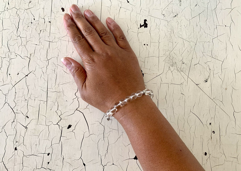 clear quartz crystal bracelet on female wrist. 