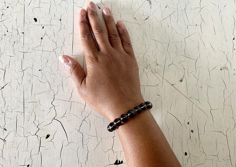 brown smokey quartz crystal bracelet large beads on female wrist. 