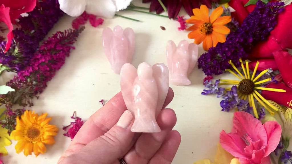 a video showing all sides of the pink rose quartz angel.