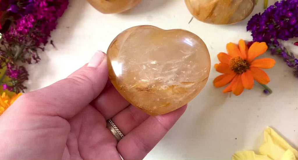 a video showing all sides of a golden healer crystal heart