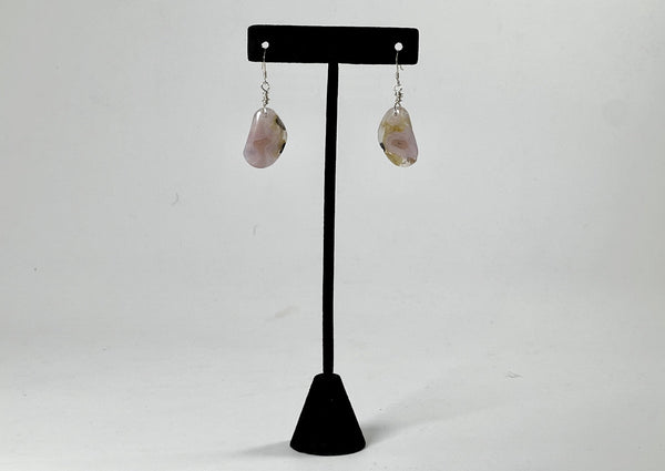 agate free from with druzy inclusions earrings hanging from t stand. 