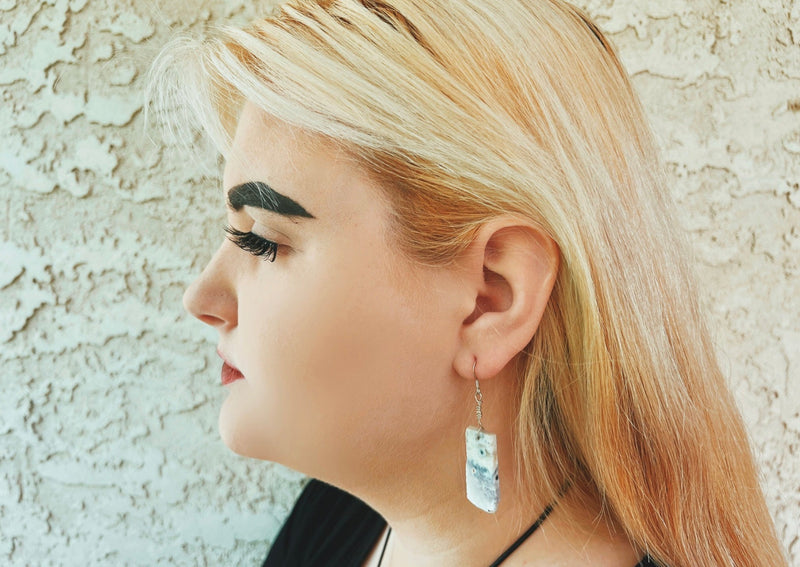 Mexican Opal sterling silver earrings on model's ear. 