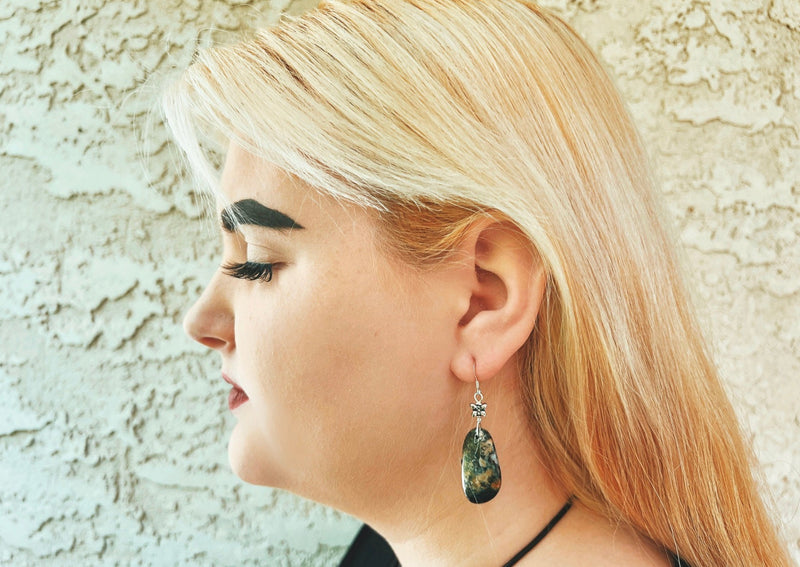 Agate earrings hanging from model's ear. 
