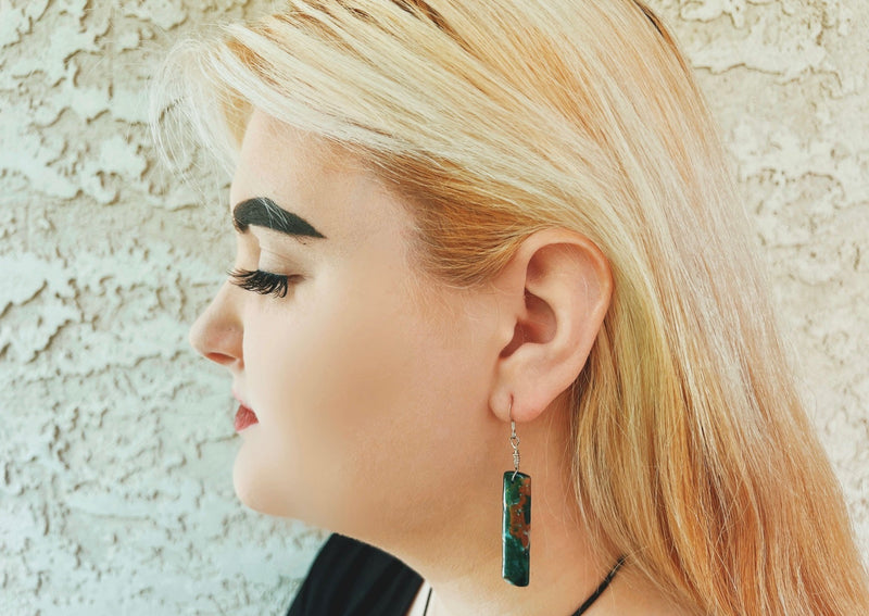 Malachite and Chrysocolla rectangular earrings on model. 