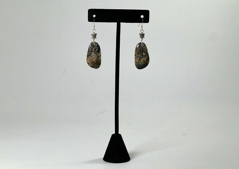 Agate earrings hanging from t stand. 