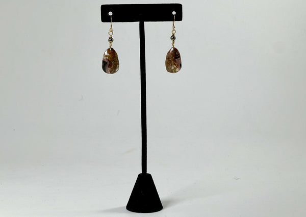 agate free form earrings hanging from t stand