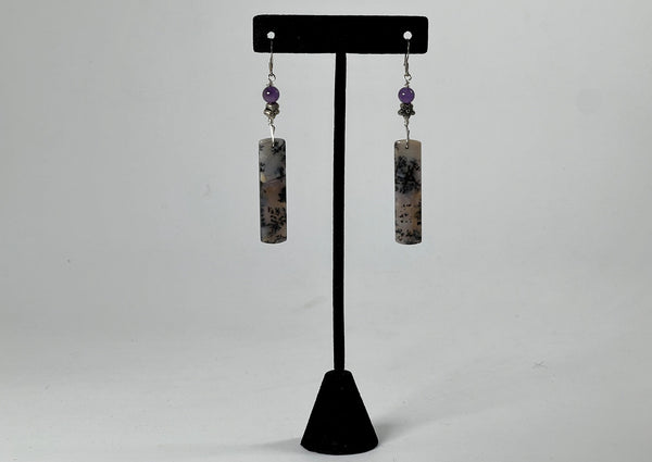 Sage Chalcedony rectangular earrings hanging on black t stand. 
