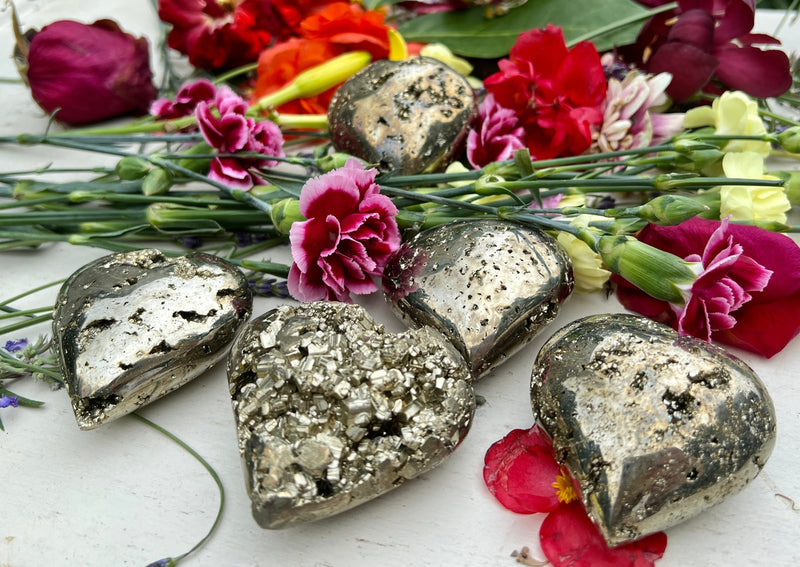 several pyrite crystal hearts on tabletop