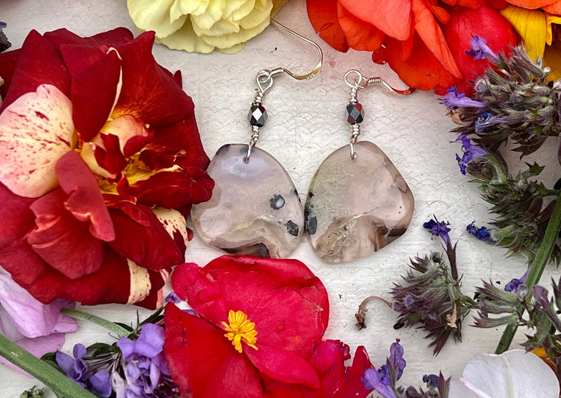 Dendritic Agate earrings on table with flowers.