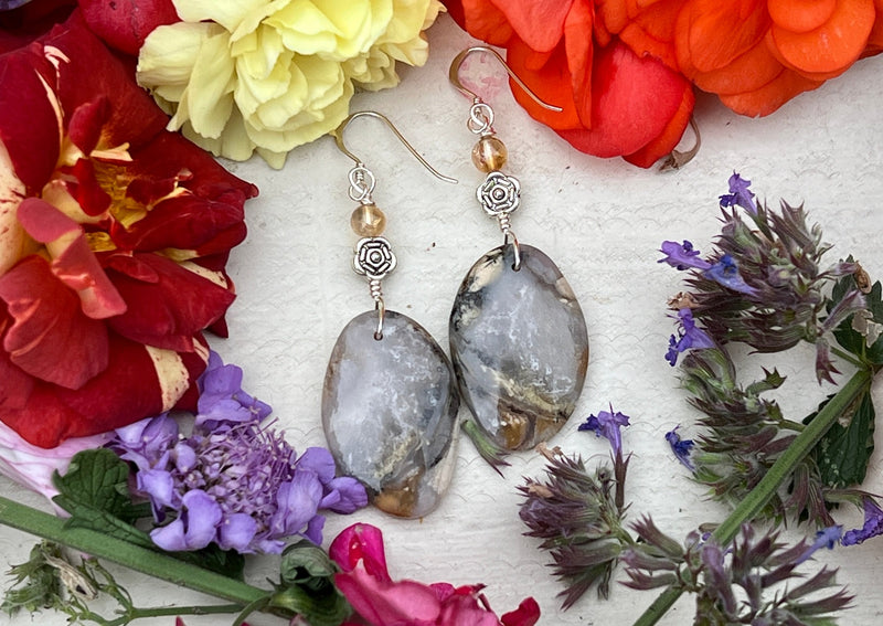 Moss Agate earrings  on table with flowers. 