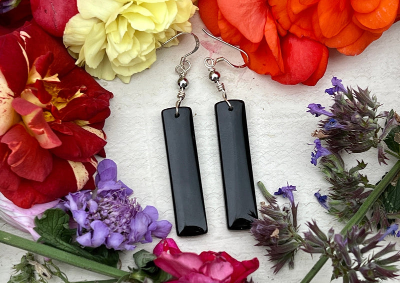 Black Obsidian Earrings on table with flowers.