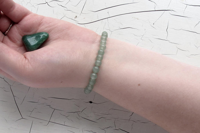 green aventurine energy bracelet on models arm with crystal 